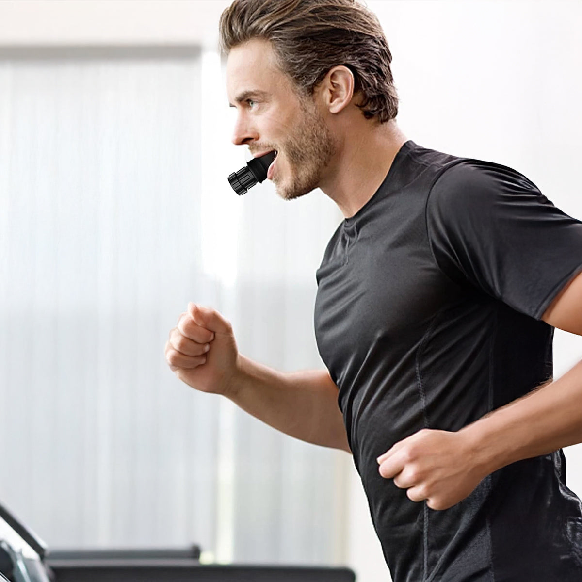 Men Running with Black VO2 Max Breath Trainer for Lung Strength and Cardio while Running on Treadmill